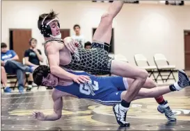  ?? TIM GODBEE / For the Calhoun Times ?? Gordon Central’s Shane Davis (bottom) tries to get Calhoun’s Brock Parker to the mat as the two battle in their match in the 120-pound weight class on Wednesday night. Parker earned a close 4-3 decision win in the match.