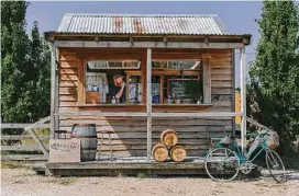  ??  ?? Drinks are sold at a roadside stall at the Shene Distillery in Tasmania, where gin makers are creating a name for themselves.