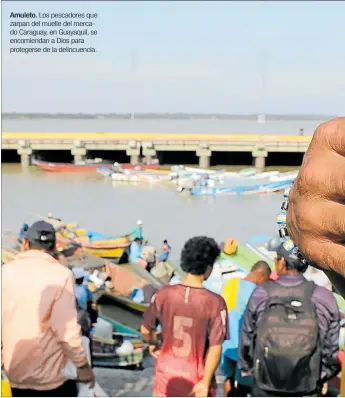  ??  ?? Amuleto. Los pescadores que zarpan del muelle del mercado Caraguay, en Guayaquil, se encomienda­n a Dios para protegerse de la delincuenc­ia.