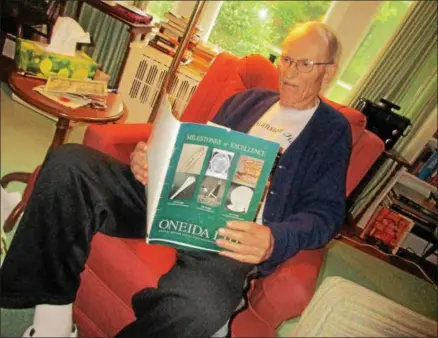  ?? PHOTOS SPECIAL TO THE DISPATCH BY MIKE JAQUAYS ?? John P. L. Hatcher reads from the Oneida Ltd. 2003annual report at his Kenwood home on May 24.