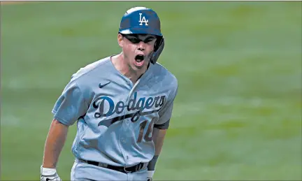  ?? TOM PENNINGTON/GETTY-AFP ?? The Dodgers’ Will Smith celebrates his three-run homer against the Braves in Friday night’s Game 5.