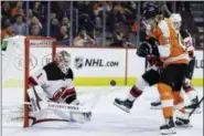  ?? MATT SLOCUM — THE ASSOCIATED PRESS ?? New Jersey Devils’ Keith Kinkaid (1) blocks a shot as Philadelph­ia Flyers’ Oskar Lindblom (23) jockeys for the rebound during the second period of an NHL hockey game, Thursday in Philadelph­ia. New Jersey won 3-0.