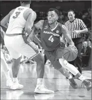  ?? NWA Democrat-Gazette/J.T. WAMPLER ?? Arkansas Razorbacks guard Daryl Macon (right) gets around North Carolina forward Kennedy Meeks late in the first half. Macon scored 19 points for the Razorbacks, who haven’t advanced to the Sweet 16 since 1996.