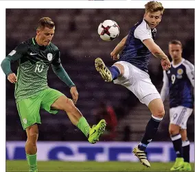  ??  ?? FLY GUY: Armstrong beats Slovenia’s Valter Birsa to the ball in March’s 1-0 win