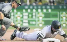  ?? Phil Long/Associated Press ?? Chris Stewart, right, hit a two-run triple Monday against the Diamondbac­ks, but might have injured himself running to third base.