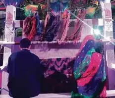  ?? Courtesy: FBMI ?? Sharifeh and her brother weaving a carpet at the FBMI stall at the Shaikh Zayed Heritage Festival in Abu Dhabi.