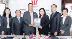  ??  ?? Winner managing director Jane Wongisariy­akul (centre left) and Suvabha Charoenyin­g, managing director of Thanachart Securities, exchange contracts after Winner appointed Thanachart as financial adviser for its IPO.