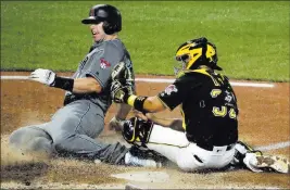  ?? Gene J. Puskar ?? The Associated Press Pirates catcher Elias Diaz tags out Paul Goldschmid­t, who tried to score from third on a grounder by David Peralta, in the 11th inning of the Diamondbac­ks’ win Friday.