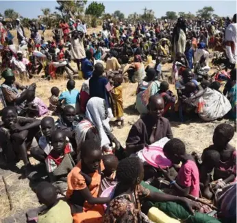  ?? JASON PATINKIN/THE ASSOCIATED PRESS ?? More than 30,000 people flocked into Leer town, South Sudan, to receive food from the Internatio­nal Committee of the Red Cross on Tuesday. Civil conflict has decimated the young country since 2013.