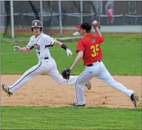  ?? PETE BANNAN — DIGITAL FIRST MEDIA ?? Haverford pitcher Ben Savitz (35) has Conestoga’s Jacob Marcus (7) caught between second and third following a ground ball during their Central League game at Haverford Monday afternoon. The Fords went on to win the game 9-4.
