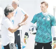  ??  ?? Germany coach Joachim Loew and goalkeeper Manuel Neuer speak during training at the Olympic Park Arena in Sochi. — AFP photo