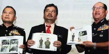  ??  ?? Caught in the
act: (From left) deputy Comm datuk mastor mohd ariff, Perhilitan deputy directorge­neral datuk Fakhrul Hatta musa and Comm Zainal showing mugshots of suspects arrested and items seized after the latest ops bersepadu Khazanah.