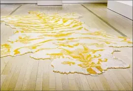  ?? Museum Associates / LACMA ?? WITH “FIRST CLASS,” Xu Bing takes an ironic look at tobacco and its power, using cigarettes arranged like a gigantic tiger rug to get his global point across.