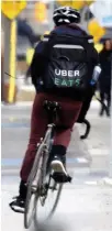  ??  ?? An UBEREATS delivery worker is seen on Toronto’s Waterfront Trail in 2017.