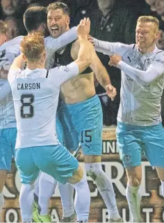  ?? ?? Inverness defender Kirk Broadfoot, who will soon be 38, celebrates with team-mates after scoring the winning penalty in the shoot-out against Arbroath at Gayfield.