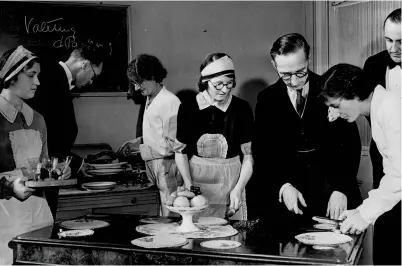 ??  ?? Students at the Domestic Training School in Sloane Street, London, practice preparing and serving food in 1937