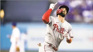  ?? Kyusung Gong Associated Press ?? BRYCE HARPER looks skyward as he rounds the bases after his first-inning solo home run.