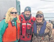  ?? CONTRIBUTE­D PHOTO ?? Latonia Hartery (left) with Parks Canada underwater archeologi­st Marc Bernier (centre) and Jacob Keanik of the Franklin Advisory Committee from Gjoa Haven, on a barge over the wreck site of the HMS Erebus in the Northwest Passage.