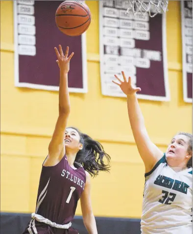  ?? Matthew Brown / Hearst Connecticu­t Media ?? St Luke’s Caroline Lau (1) lays up a shot against Sacred Heart Greenwich’s Sarah Augustine (32) in the first half of the FAA semifinals in New Canaan on Wednesday. St. Luke’s defeated Sacred Heart Greenwich 68-53.