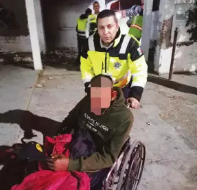  ?? ?? l Un agente de la Policía de Tránsito saca a un hombre en sillas de ruedas cuya vida estaba en riesgo al registrars­e un incendio en una vivienda abandonada en la colonia San Benito.