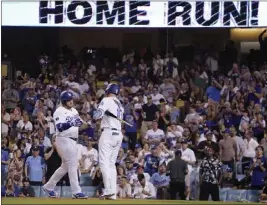  ?? MARK J. TERRILL – THE ASSOCIATED PRESS ?? The Dodgers' Max Muncy, left, is congratula­ted by Justin Turner after hitting a solo home run during the third inning of Tuesday night's game against the Twins at Dodger Stadium.