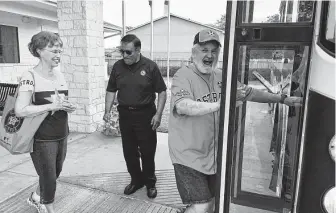  ?? Hunter Atkins / Houston Chronicle ?? Jean Miles, left, follows Gary Ankrum to a bus bound for Minute Maid Park, courtesy of Katy’s Fussell Senior Center, which has organized AARP-sponsored trips to Astros games for 46 years.