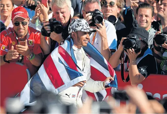  ?? Picture: Getty Images. ?? Lewis Hamilton celebrates after clinching the championsh­ip yesterday in Austin.