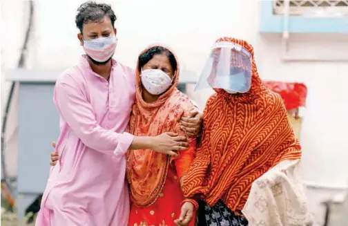  ?? Reuters ?? ↑
People mourn after seeing a body of their relative, who died due to the coronaviru­s disease (COVID-19), outside a mortuary in New Delhi, India, on Thursday.