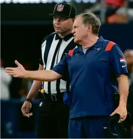  ?? MATTHEW J LEE/GLOBE STAFF ?? Coach Bill Belichick spent most of the game searching for answers, in this case from field judge Trawick Boger (left).