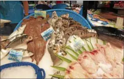  ?? JANET PODOLAK — THE NEWS-HERALD ?? A variety of glistening fresh fish is artfully displayed in the Victor Hugo Covered Market in Toulouse.