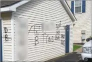  ?? GLENN GRIFFITH — GGRIFFITH@DIGITALFIR­STMEDIA.COM ?? Graffiti sprayed on a residence in the Landings, 5 Plant Road in Halfmoon. NOTE: This photo has been altered as some of the words may be offensive to some readers.