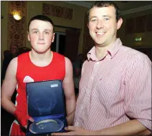  ??  ?? Dan Houlihan winner in the 72kg class receives his prize from Cllr Andrias Moynihan at the Rylane Boxing Club match up with NYFD