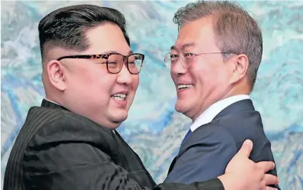  ??  ?? North Korean leader Kim Jong Un and South Korean President Moon Jae-in embrace ahead of talk during a historic summit on April 27, 2018.