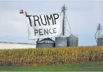  ?? MARK MAKELA/NEW YORK TIMES ?? A huge sign supporting President Donald Trump and Vice President Mike Pence hangs above corn silos on a farm in Lititz, Pa., last month. Despite one of the worst years in recent American history, the issue on which Trump gets his highest approval ratings remains the economy.