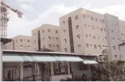  ?? FILE ?? In this June 29, 2017 photo, new dorm rooms at Irvine Hall developed by 138 Student Living Jamaica Limited are seen in the background, while a section of the old structure is in the foreground.