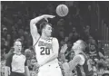  ?? AP ?? Suns forward Dario Saric (20) passes over Celtics forward Daniel Theis Saturday in Boston.