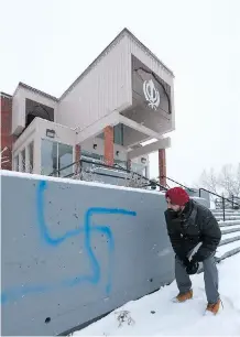  ?? FILES ?? Harpeet Singh Gill, a volunteer at the Sikh Society of Calgary, examines graffiti at the building on 81 Street S.W. in 2016. The federal government is giving the organizati­on about $79,000 for security upgrades.