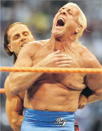  ?? JACOB LANGSTON/THE ASSOCIATED PRESS FILES ?? Ric Flair, right, reacts as Shawn Michaels puts him in a hold during the Career Threatenin­g Match at WrestleMan­ia XXIV at the Citrus Bowl in Orlando, Fla. If Andy Dunn has his way, Flair could be signing autographs at this year’s Vancouver Canadians Superstar Series.