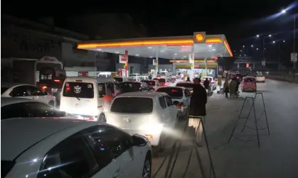  ?? Photograph: Hussain Ali/Pacific Press/REX/Shuttersto­ck ?? People queueing for fuel at a petrol station after a country-wide power breakdown due to a government energy-saving measure, Peshawar, Pakistan, 23 January 2023.