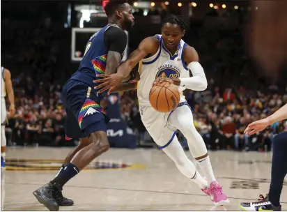  ?? NHAT V. MEYER — BAY AREA NEWS GROUP ?? Golden State Warriors' Jonathan Kuminga (00) dribbles against Denver Nuggets' JaMychal Green (0) in the second quarter of Game 4of the team's NBA basketball first-round playoff series at Ball Arena in Denver, Colo.