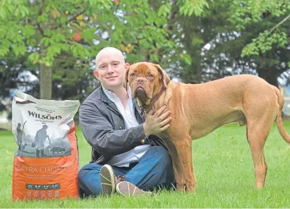  ?? Picture: Julie Howden. ?? Craig Wallace of Wilson’s Pet Food in Perthshire with puppy Bruce.