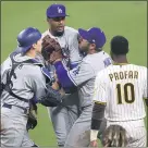  ?? SEAN M. HAFFEY – GETTY IMAGES ?? Dodgers pitcher Dennis Santana, second from left, is held back by Will Smith, left, and Max Muncy as he confronts Jurickson Profar of the Padres following a hit batsman on Friday.