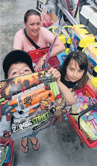  ?? Photos: ROSS GIBLIN/FAIRFAX NZ ?? Toys galore: Sarah Gerondis with her children Matthew, 5, and Zoe, 8, taking advantage of Boxing Day sales to buy toys and camping gear.