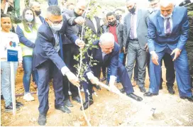  ?? (Raneen Sawafta/Reuters) ?? PA PRIME MINISTER Mohammad Shtayyeh plants a tree during a ceremony in Tayasir in the northern West Bank last month.