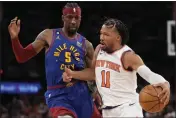  ?? MARY ALTAFFER — THE ASSOCIATED PRESS ?? New York Knicks guard Jalen Brunson (11) drives against Denver Nuggets guard Kentavious Caldwell-Pope (5) during the second half on Saturday at Madison Square Garden in New York.