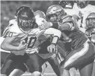  ?? MATT PARKER ?? Portsmouth’s Fletcher Miles (53) pulls down Bedford quarterbac­k Danny Black during a Division I semifinal against Bedford this fall. Miles was named a Division I all-state first-team player.