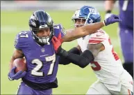  ?? Nick Wass / Associated Press ?? Ravens running back J.K. Dobbins is pushed out of bounds by Giants free safety Logan Ryan on Dec. 27.