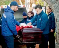  ?? — Reuters ?? Forensic service staff carry the coffin of Chilean poet and Nobel laureate Pablo Neruda during the reburial of his remains inside of his house-museum in Isla Negra city, Chile, on Tuesday.