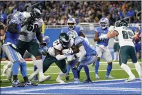  ?? PAUL SANCYA — THE ASSOCIATED PRESS ?? Eagles running back Jordan Howard blasts in for a touchdown against the Detroit Lions Sunday.