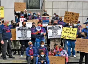  ?? STAFF PHOTO BY WYATT MASSEY ?? Lakecha Strickland, president of Amalgamate­d Transit Union Local 1212, speaks Sunday during a rally on Market Street for the reinstatem­ent of hazard pay for CARTA drivers.